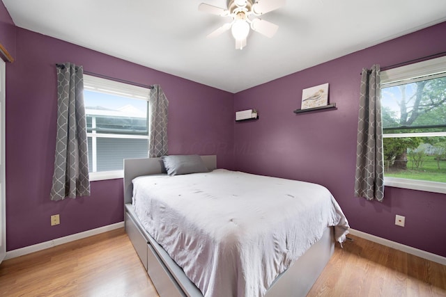 3233 Burdett Ct, Columbus, OH 43232 - bedroom with multiple windows, light wood-style flooring, baseboards, and a ceiling fan
