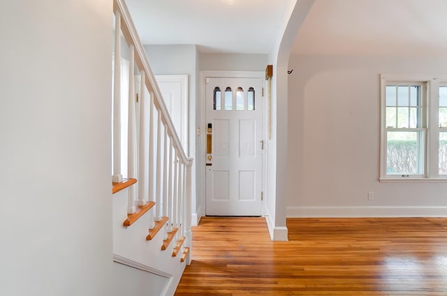 789 Chelsea Ave, Columbus, OH 43209 - foyer entrance featuring arched walkways, wood finished floors, baseboards, and stairway