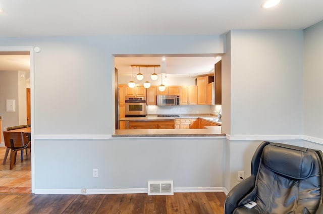 789 Chelsea Ave, Columbus, OH 43209 - kitchen with stainless steel appliances, wood finished floors, light brown cabinetry, recessed lighting, and a peninsula