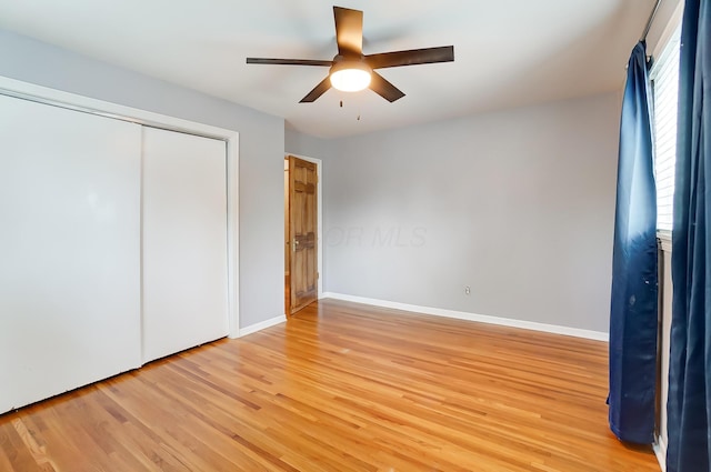 789 Chelsea Ave, Columbus, OH 43209 - unfurnished bedroom with light wood-style floors, baseboards, a closet, and a ceiling fan