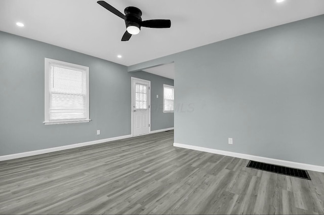 spare room featuring baseboards, ceiling fan, wood finished floors, and recessed lighting