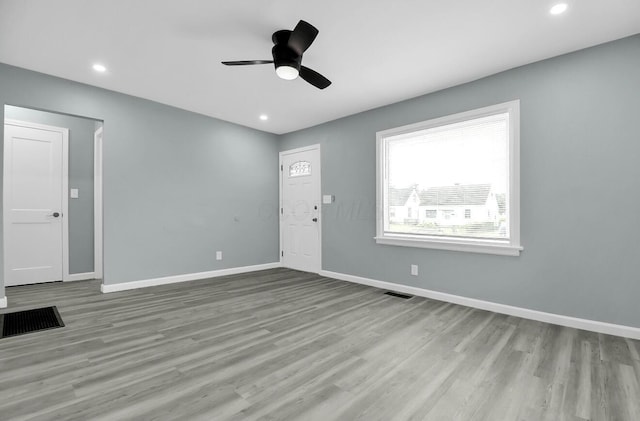 spare room featuring wood finished floors, baseboards, a ceiling fan, and recessed lighting