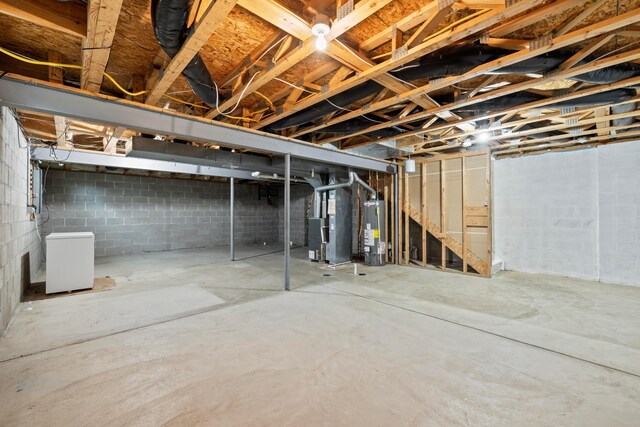 1608 Geranium Dr, Lewis Center, OH 43035 - unfinished basement featuring water heater, heating unit, concrete block wall, and stairway