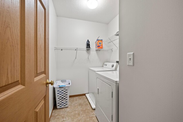 1608 Geranium Dr, Lewis Center, OH 43035 - laundry area with washer and dryer, light tile patterned flooring, and baseboards