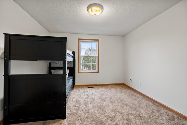 1608 Geranium Dr, Lewis Center, OH 43035 - unfurnished bedroom with carpet, a textured ceiling, and baseboards