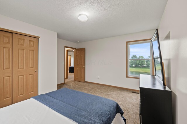 1608 Geranium Dr, Lewis Center, OH 43035 - carpeted bedroom with baseboards, a textured ceiling, and a closet