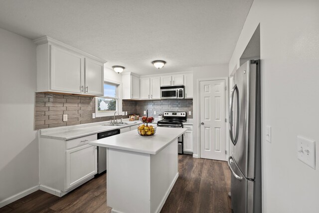 1608 Geranium Dr, Lewis Center, OH 43035 - kitchen featuring stainless steel appliances, dark wood finished floors, tasteful backsplash, light countertops, and white cabinets