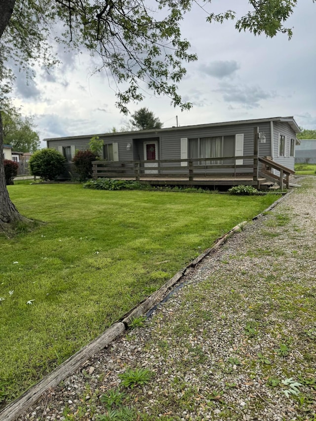 back of house with a yard and a wooden deck