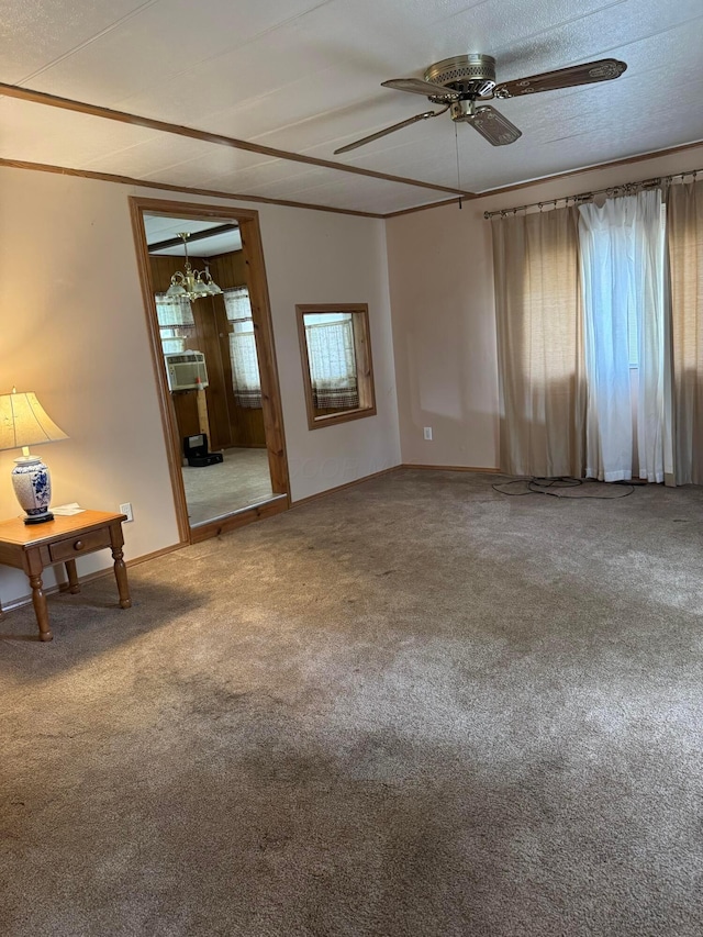 carpeted spare room featuring ceiling fan and baseboards