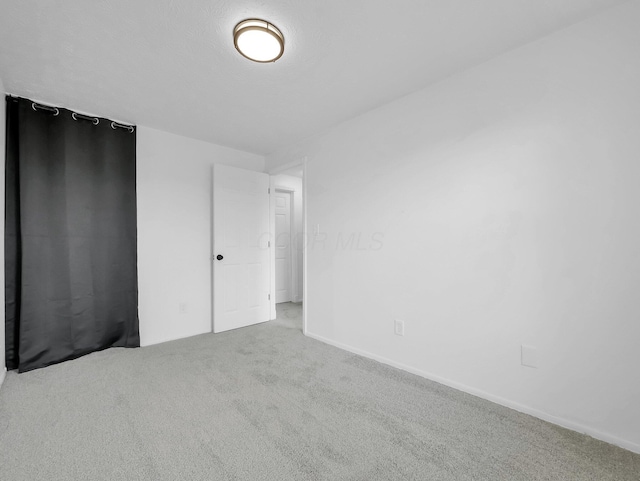 unfurnished bedroom with carpet floors and baseboards