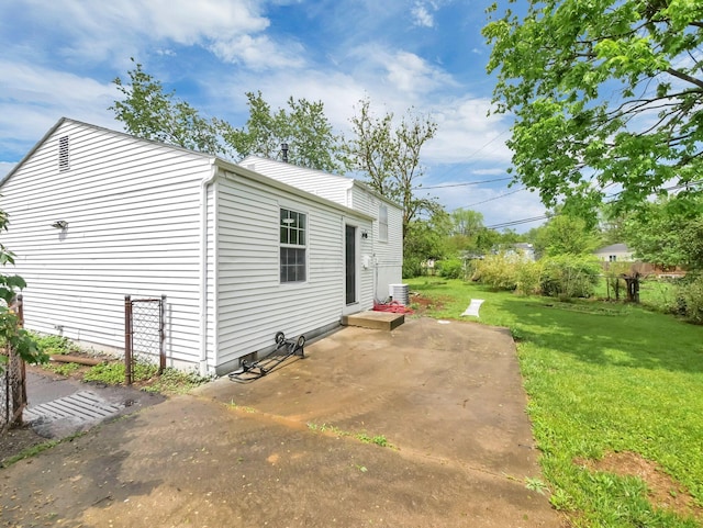 view of property exterior with a yard and a patio