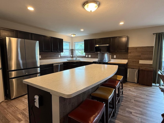210 Glemsbury Dr, Delaware, OH 43015 - kitchen featuring appliances with stainless steel finishes, a sink, light countertops, wood finished floors, and recessed lighting