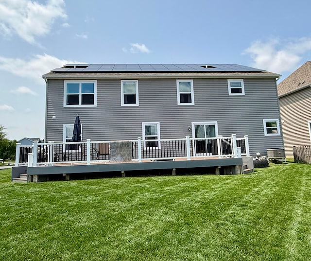 210 Glemsbury Dr, Delaware, OH 43015 - rear view of house featuring roof mounted solar panels, a lawn, and a wooden deck