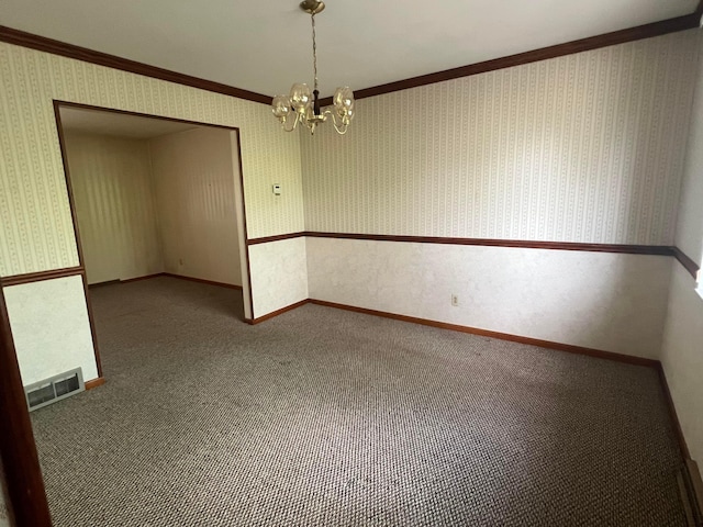 carpeted empty room with a chandelier, ornamental molding, wallpapered walls, and baseboards