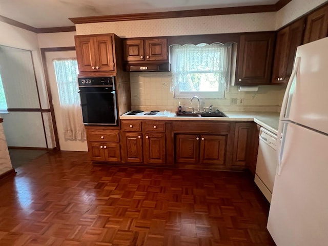 kitchen featuring white appliances, a sink, light countertops, crown molding, and tasteful backsplash