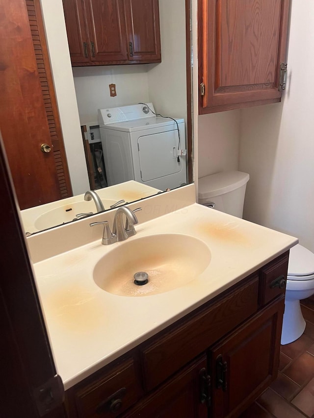 bathroom featuring toilet, vanity, and tile patterned floors