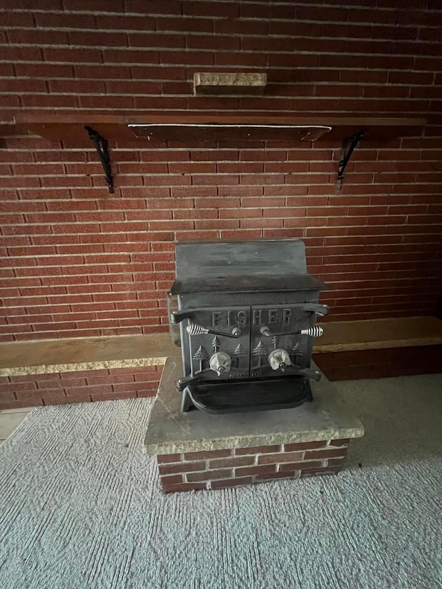 detailed view of a wood stove, brick wall, and carpet floors