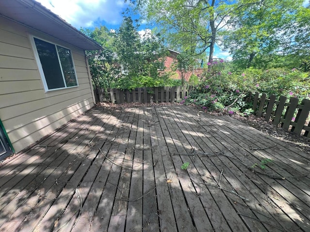 wooden terrace featuring fence