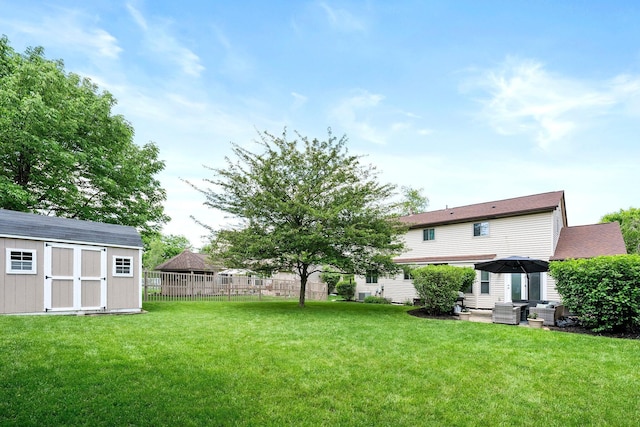 view of yard featuring a storage shed, an outdoor living space, an outdoor structure, and a patio area