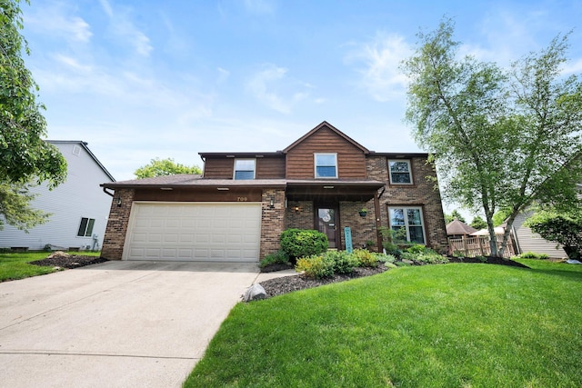 view of front of house featuring a front lawn, driveway, brick siding, and an attached garage