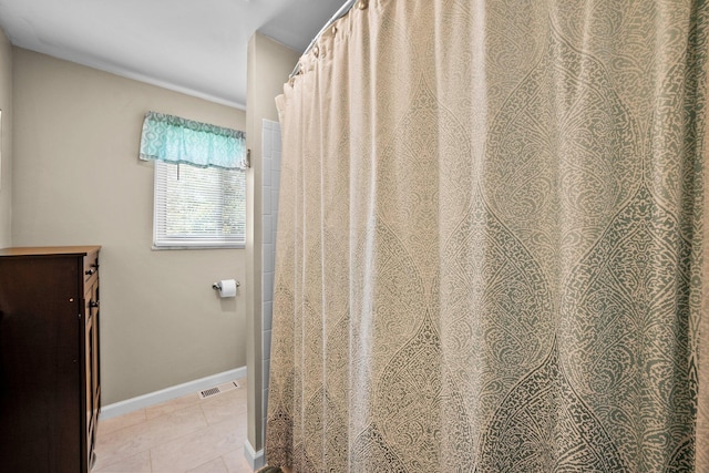 bathroom featuring tile patterned floors and baseboards