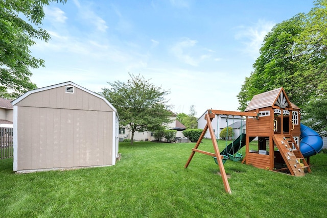 view of grassy yard featuring a playground, an outbuilding, and a storage shed