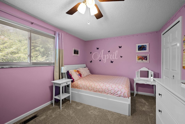 carpeted bedroom featuring a textured ceiling, a ceiling fan, and baseboards