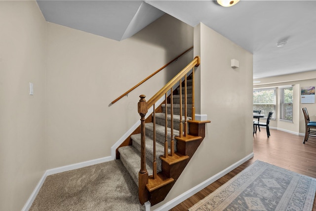 stairs featuring baseboards and wood finished floors