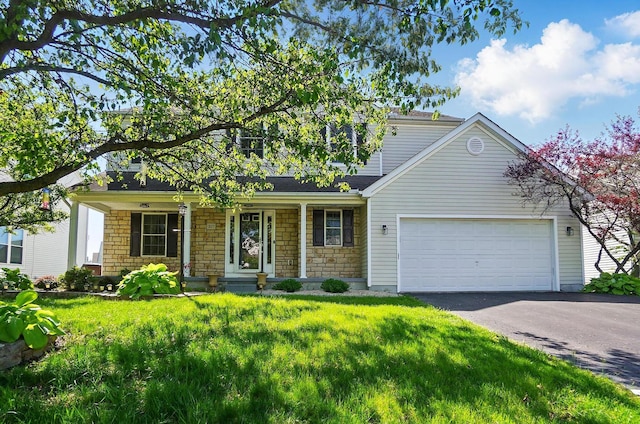 317 Audubon St, Pickerington, OH 43147 - view of front of home featuring asphalt driveway, a garage, a porch, stone siding, and a front lawn