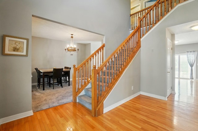 317 Audubon St, Pickerington, OH 43147 - staircase featuring hardwood / wood-style floors, baseboards, and a chandelier