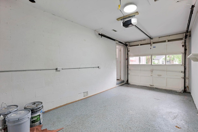 234 Rosslyn Ave, Columbus, OH 43214 - garage featuring a garage door opener and concrete block wall