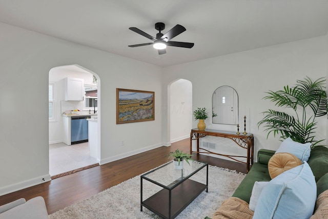 234 Rosslyn Ave, Columbus, OH 43214 - living room with arched walkways, light wood-type flooring, a ceiling fan, and baseboards