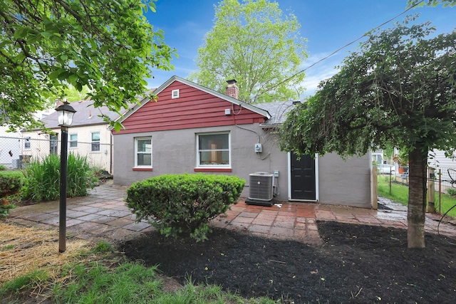234 Rosslyn Ave, Columbus, OH 43214 - back of house featuring a chimney, central AC, fence, and a shingled roof