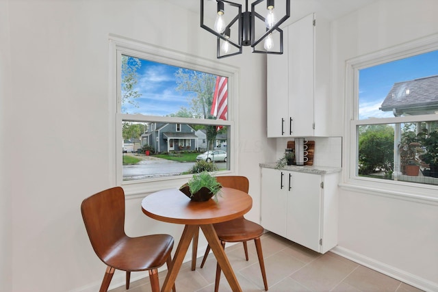 234 Rosslyn Ave, Columbus, OH 43214 - dining space with a chandelier, baseboards, and light tile patterned floors
