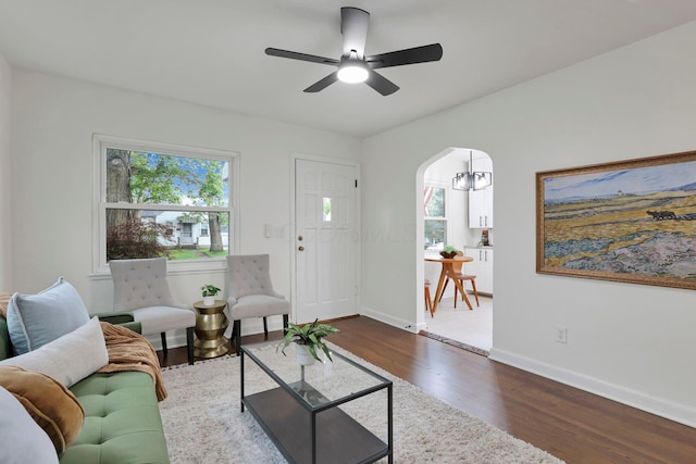 234 Rosslyn Ave, Columbus, OH 43214 - living room featuring plenty of natural light, dark wood-type flooring, a ceiling fan, and arched walkways