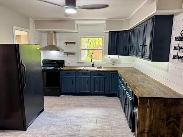 9966 Larimer Rd, Logan, OH 43138 - kitchen with black appliances, wall chimney exhaust hood, a sink, blue cabinetry, and wooden counters