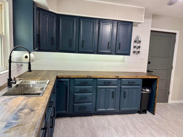 9966 Larimer Rd, Logan, OH 43138 - kitchen featuring a sink, blue cabinets, butcher block counters, and baseboards