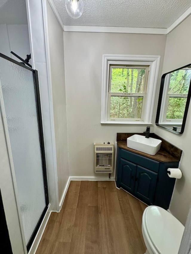 9966 Larimer Rd, Logan, OH 43138 - bathroom with heating unit, wood finished floors, a stall shower, healthy amount of natural light, and a textured ceiling
