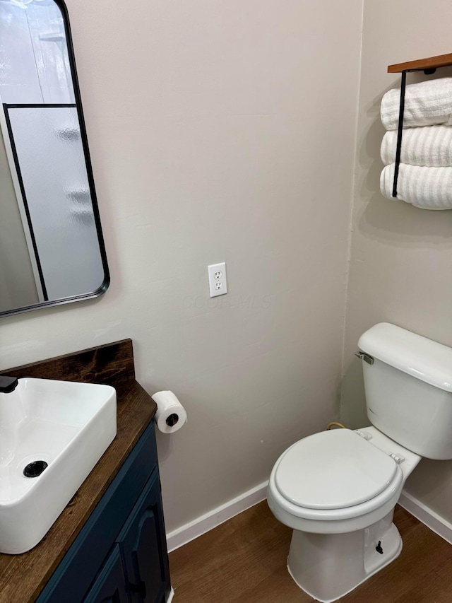 9966 Larimer Rd, Logan, OH 43138 - bathroom with baseboards, wood finished floors, toilet, and vanity