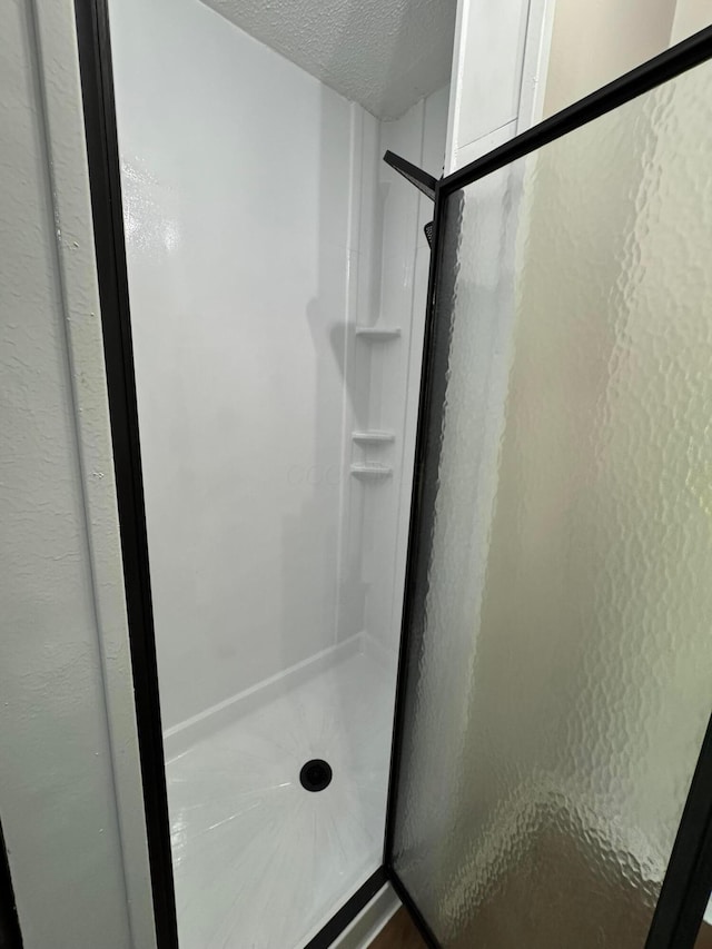9966 Larimer Rd, Logan, OH 43138 - full bath featuring a shower stall and a textured ceiling