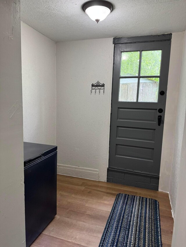 9966 Larimer Rd, Logan, OH 43138 - entryway with a textured ceiling, wood finished floors, a textured wall, and baseboards