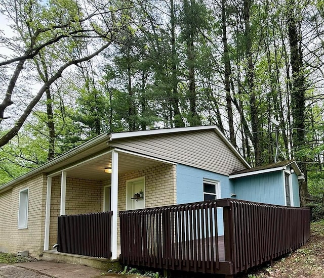 9966 Larimer Rd, Logan, OH 43138 - view of side of property featuring brick siding and a porch
