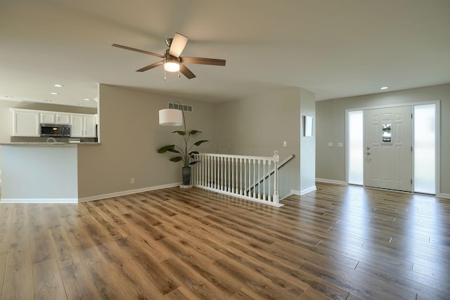 1899 Lamb Rd NW, Carroll, OH 43112 - unfurnished living room with wood finished floors, recessed lighting, a ceiling fan, and baseboards