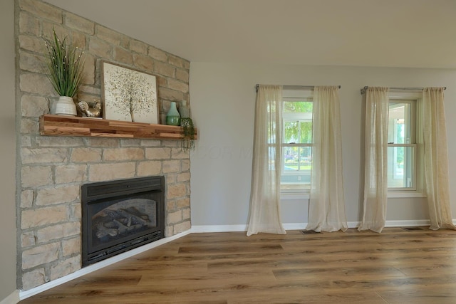 1899 Lamb Rd NW, Carroll, OH 43112 - unfurnished living room featuring wood finished floors, baseboards, and a fireplace