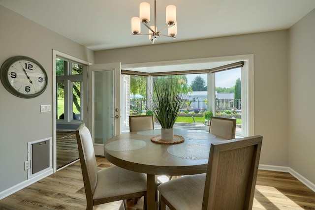 1899 Lamb Rd NW, Carroll, OH 43112 - dining room with a chandelier, light wood-style flooring, and baseboards