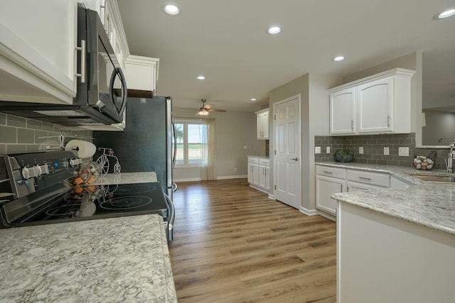1899 Lamb Rd NW, Carroll, OH 43112 - kitchen featuring range with electric stovetop, a sink, white cabinets, light wood-style flooring, and recessed lighting