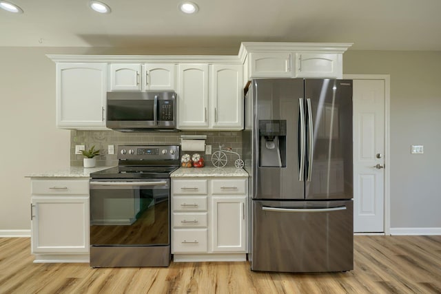 1899 Lamb Rd NW, Carroll, OH 43112 - kitchen with stainless steel appliances, white cabinets, light wood finished floors, baseboards, and tasteful backsplash
