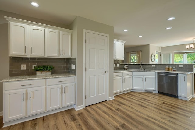 1899 Lamb Rd NW, Carroll, OH 43112 - kitchen with dishwasher, white cabinets, tasteful backsplash, light wood-type flooring, and a sink