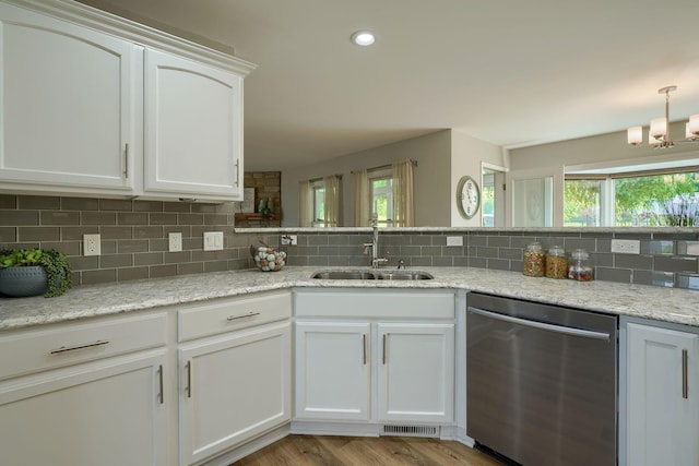 1899 Lamb Rd NW, Carroll, OH 43112 - kitchen featuring stainless steel dishwasher, a sink, decorative backsplash, white cabinetry, and a chandelier