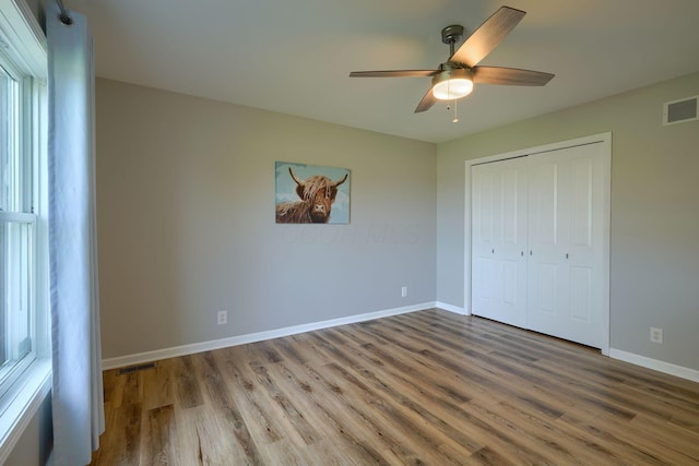 1899 Lamb Rd NW, Carroll, OH 43112 - unfurnished bedroom with wood finished floors, baseboards, a closet, and a ceiling fan